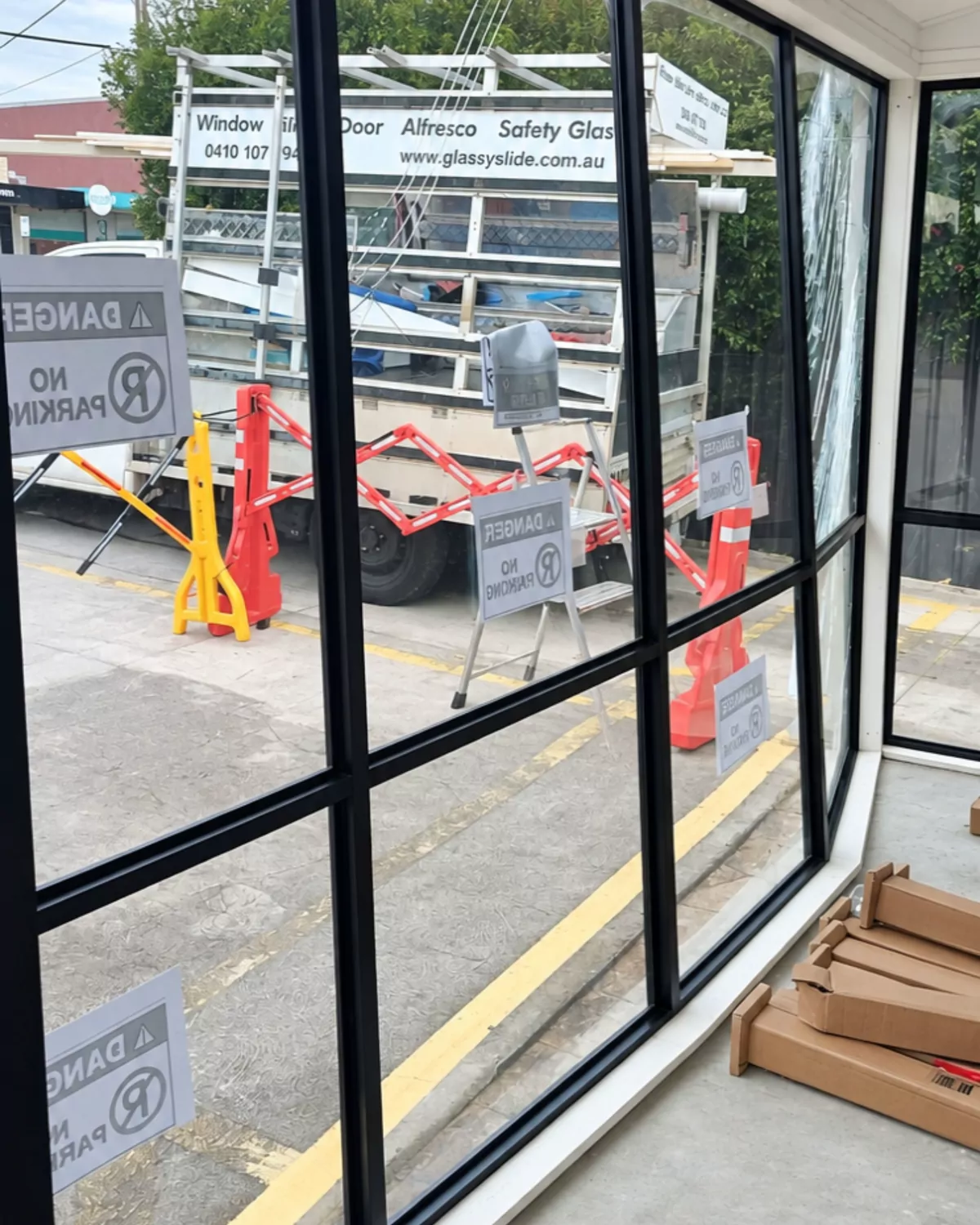 From inside: new glass panels in, with the Glassy Slide glass truck and barriers outside