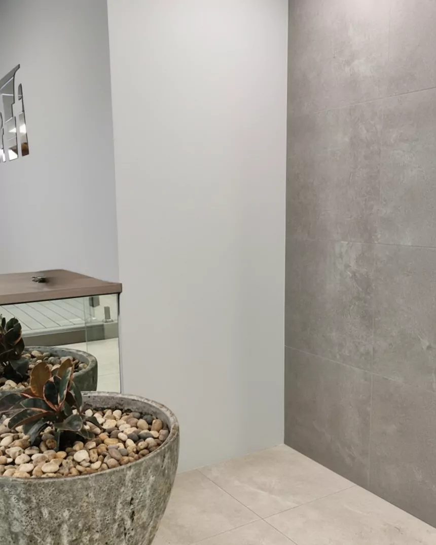 Before: an empty tiled shower corner
